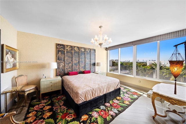 bedroom featuring an inviting chandelier and wood-type flooring