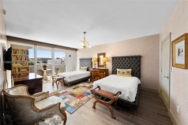 bedroom featuring hardwood / wood-style flooring and an inviting chandelier