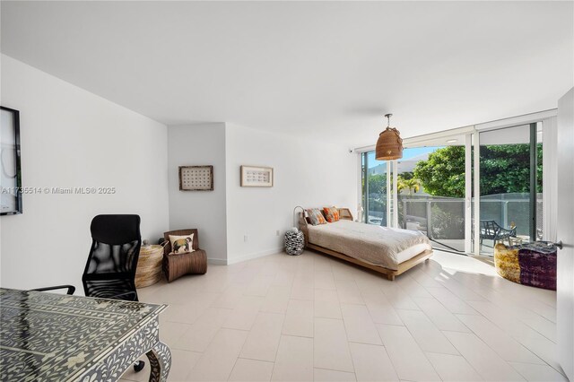 bedroom with floor to ceiling windows and access to outside