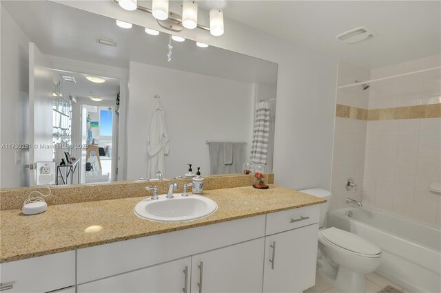 full bathroom featuring vanity, shower / bath combo, and toilet