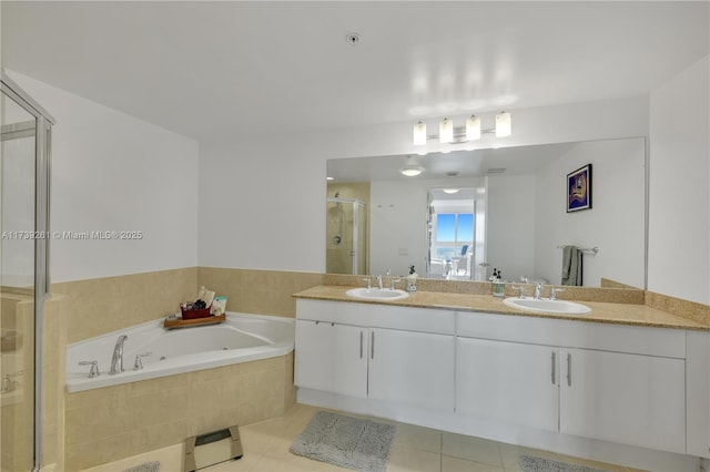 bathroom featuring tile patterned floors, vanity, and separate shower and tub