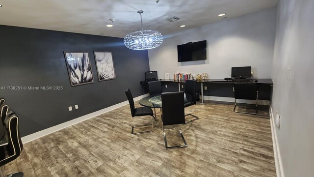 dining space with hardwood / wood-style flooring