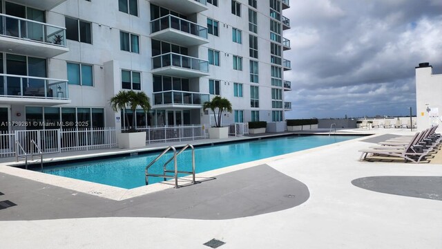 view of swimming pool with a patio and central AC