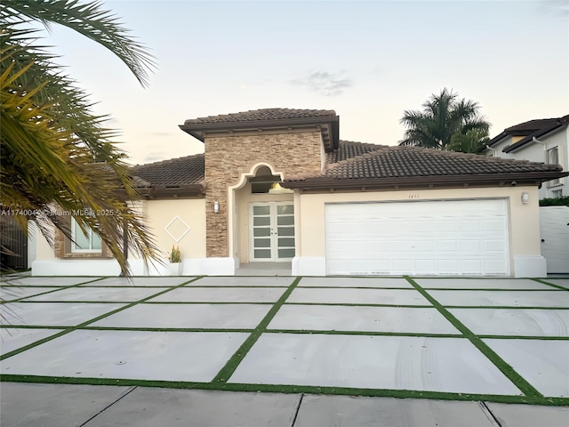 mediterranean / spanish-style home featuring a garage