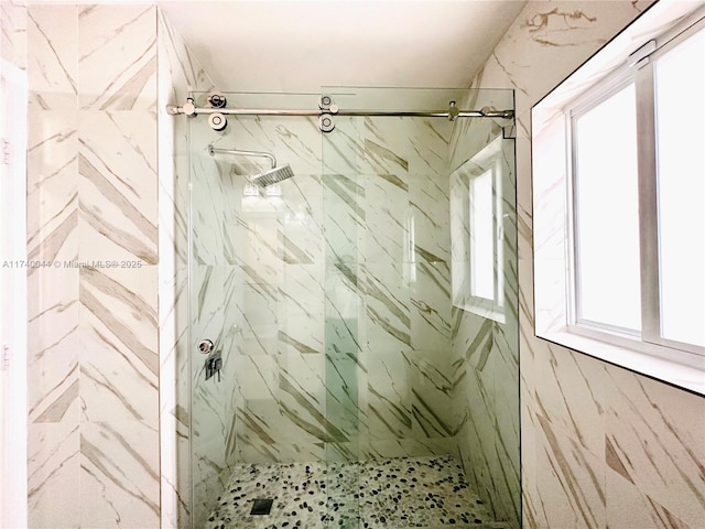 bathroom with a tile shower