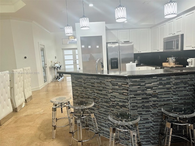 kitchen with white cabinetry, appliances with stainless steel finishes, pendant lighting, and french doors