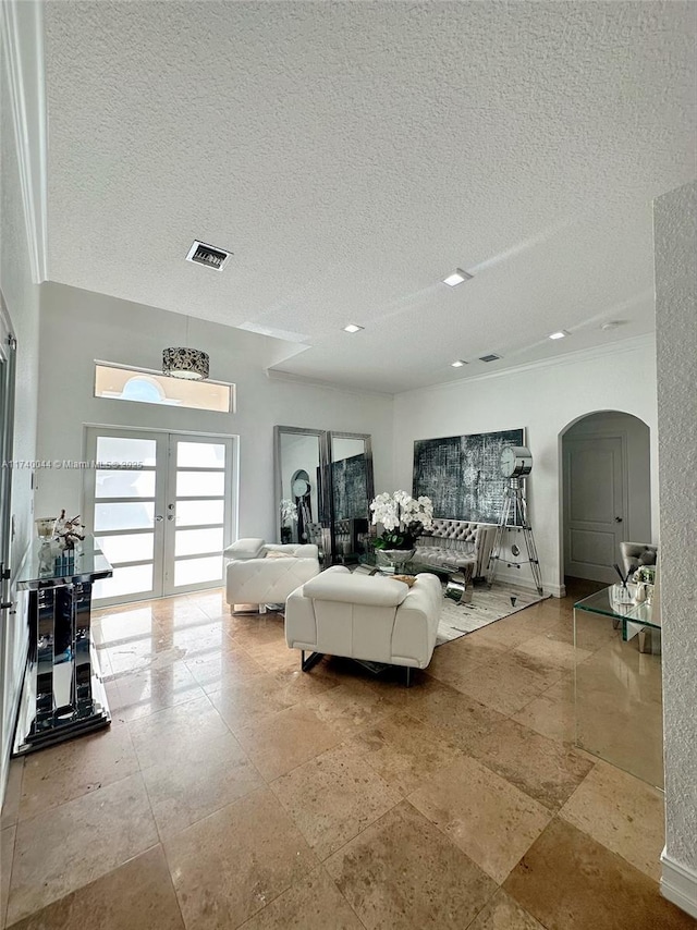 living room featuring french doors and a textured ceiling