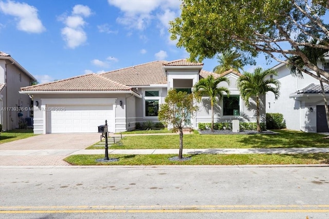 mediterranean / spanish-style home featuring a garage and a front yard