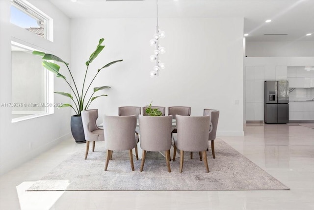 dining area featuring a high ceiling