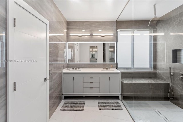 bathroom with vanity, tile walls, and a tile shower