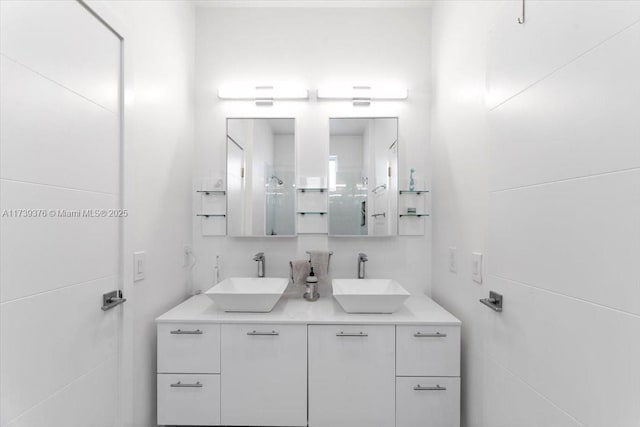 bathroom featuring vanity and tile walls