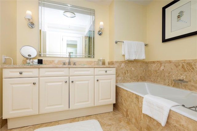 bathroom featuring vanity, tiled tub, and tile patterned floors