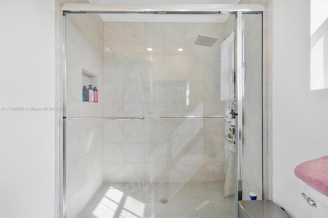 bathroom with a shower with shower door