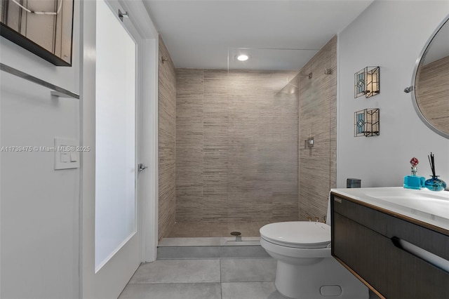 bathroom with toilet, a stall shower, tile patterned floors, and vanity