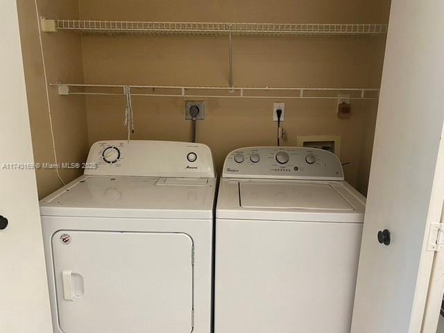 laundry room with washing machine and clothes dryer