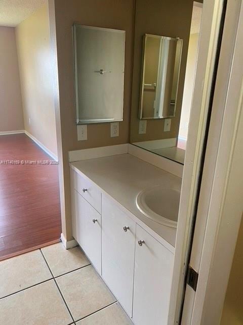 bathroom featuring vanity, tile patterned floors, and a textured ceiling