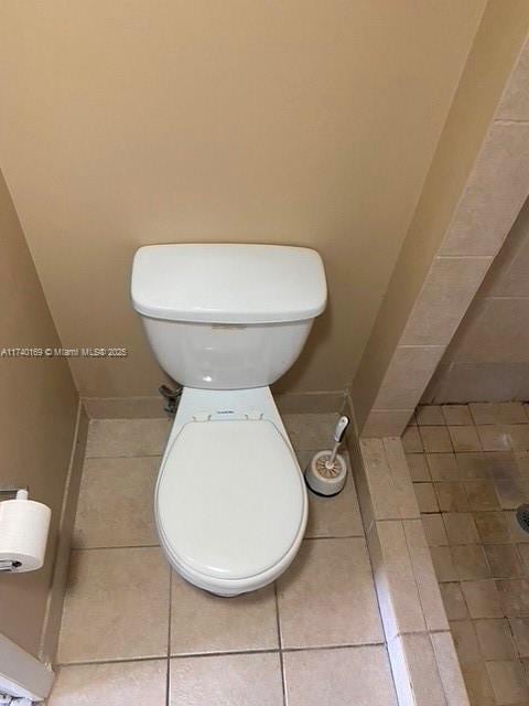 bathroom featuring toilet and tile patterned flooring