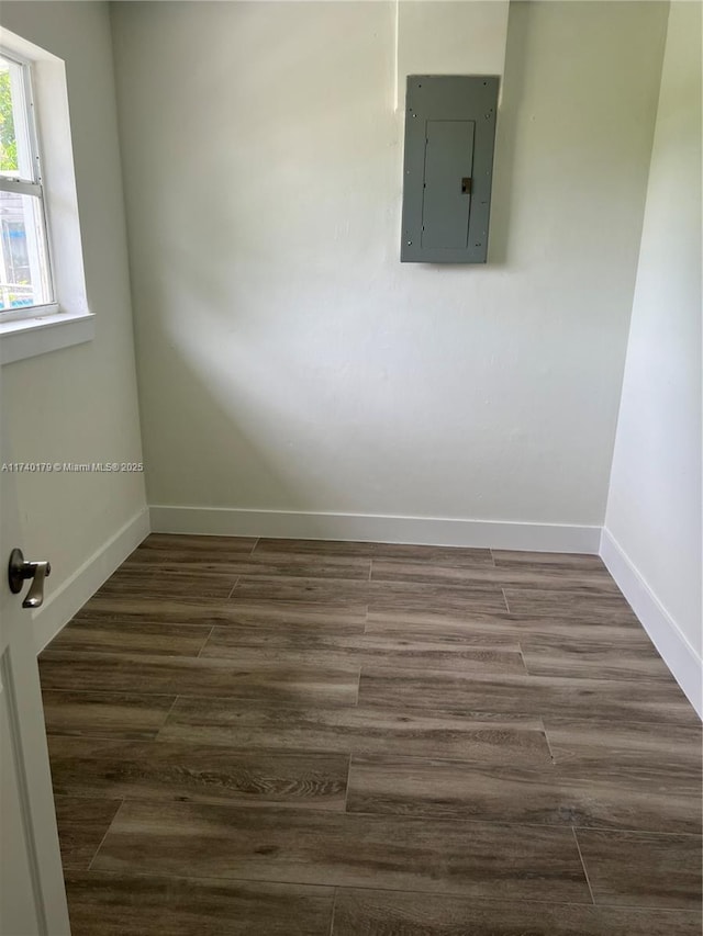 spare room featuring dark hardwood / wood-style floors and electric panel