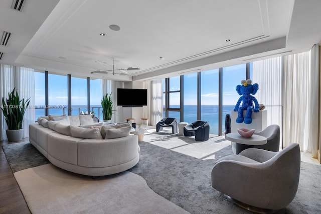 9701 Collins Ave Unit Ph01S, Bal Harbour, FL 33154 - living area with expansive windows, a tray ceiling, and wood finished floors