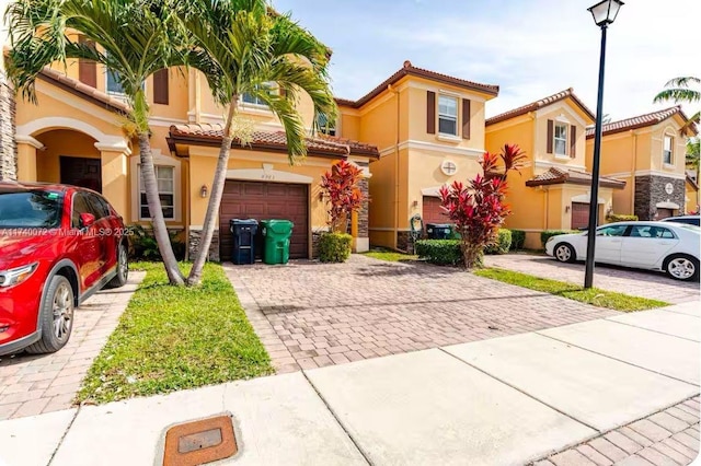 mediterranean / spanish-style home featuring a garage