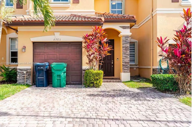 mediterranean / spanish-style home with a garage