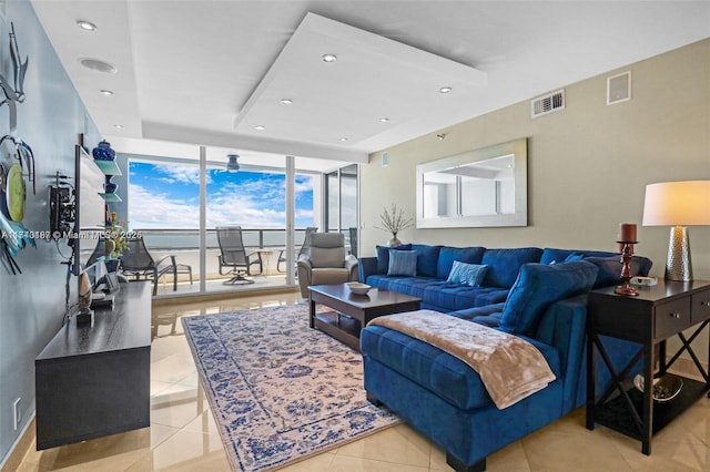 living room with light tile patterned floors and expansive windows