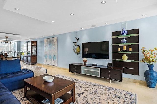 tiled living room featuring a notable chandelier