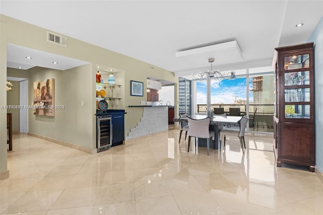 dining area with an inviting chandelier, expansive windows, and beverage cooler