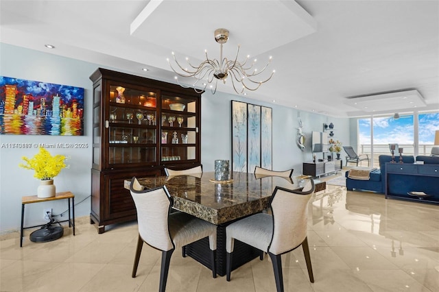 tiled dining area with a notable chandelier and a wall of windows