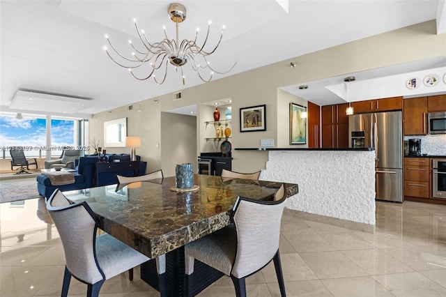 dining room featuring light tile patterned floors and a notable chandelier