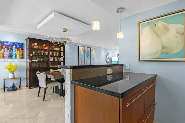 bar with an inviting chandelier and decorative light fixtures