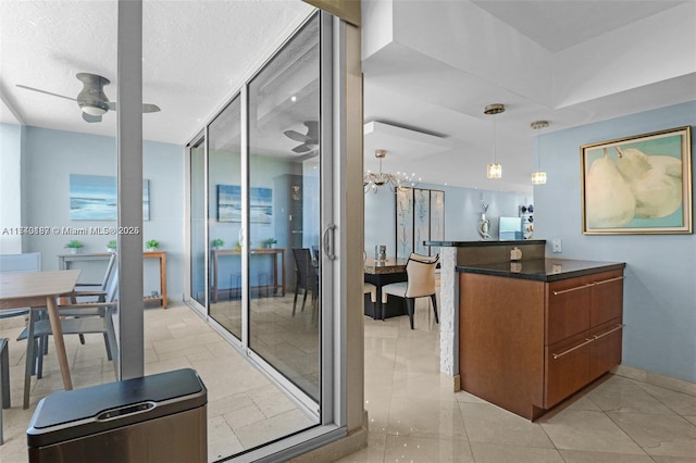 interior space with ceiling fan and a textured ceiling