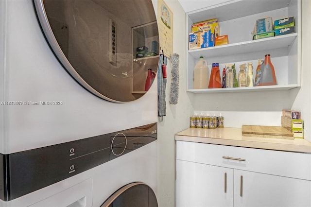 laundry area featuring stacked washer / dryer