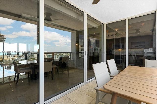 exterior space featuring a water view and ceiling fan