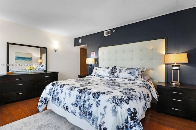 bedroom with dark wood-type flooring