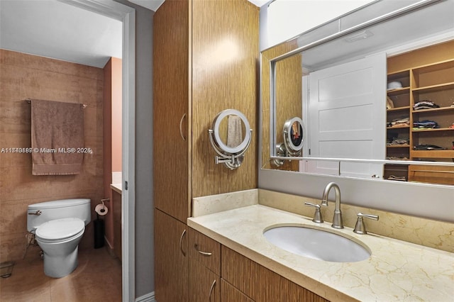 bathroom featuring tile patterned flooring, vanity, and toilet