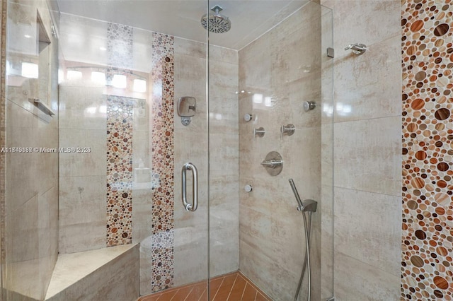 bathroom with a shower with door