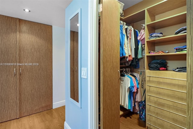 spacious closet featuring light hardwood / wood-style flooring