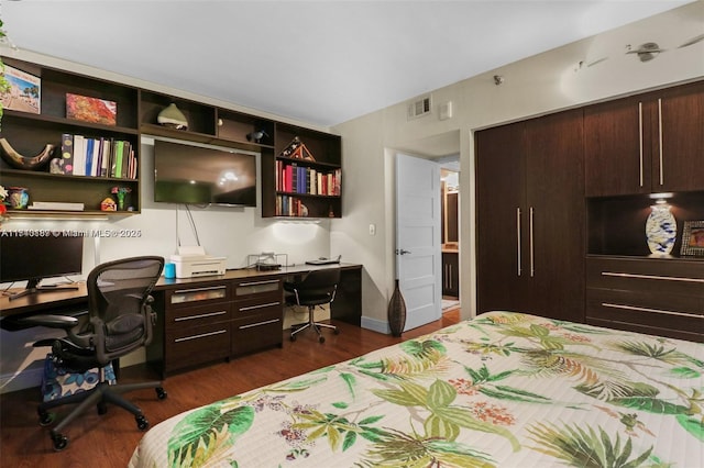 bedroom with dark hardwood / wood-style floors