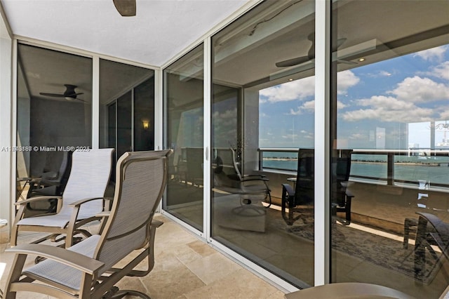 exterior space featuring a water view and ceiling fan