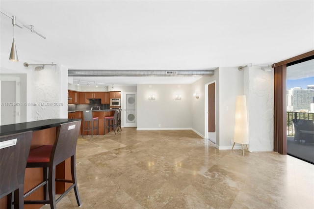 living room with track lighting and floor to ceiling windows