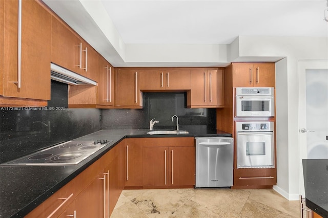 kitchen featuring tasteful backsplash, sink, stainless steel appliances, and dark stone counters