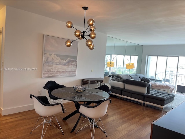 dining area featuring an inviting chandelier and wood-type flooring