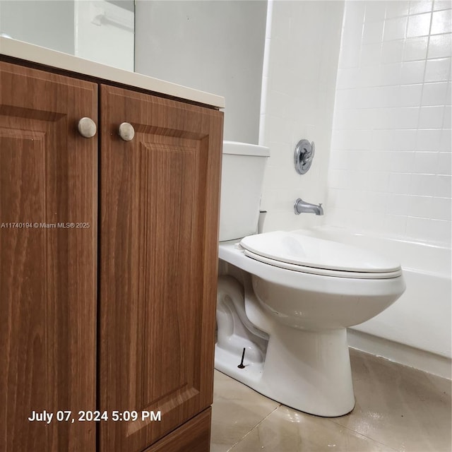 bathroom featuring shower / tub combination and toilet