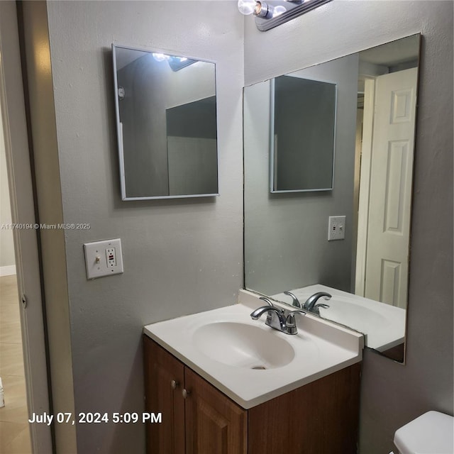 bathroom with vanity and toilet