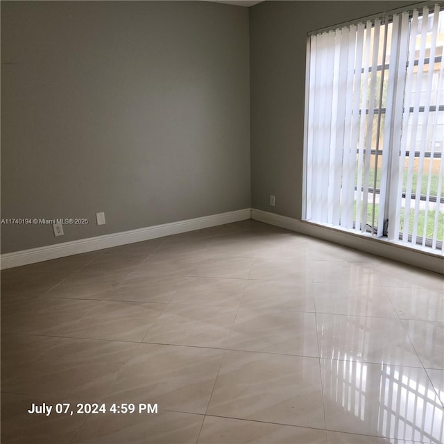 spare room with light tile patterned floors