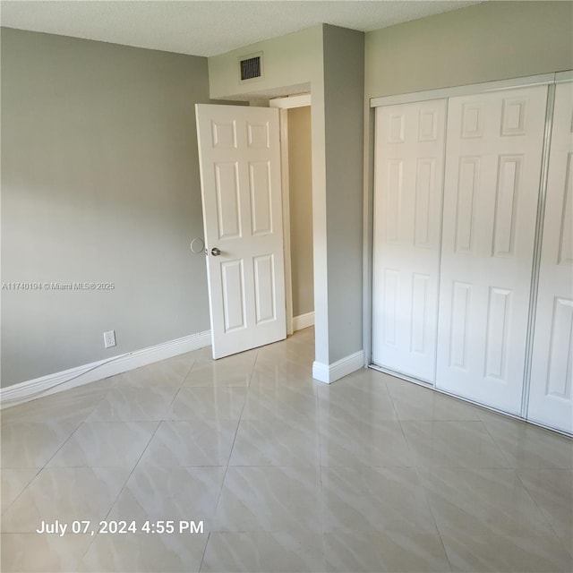 unfurnished bedroom with a closet