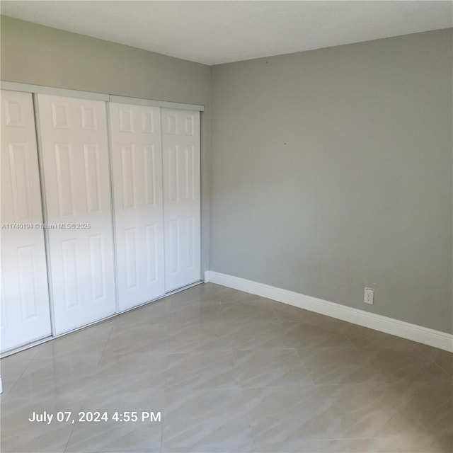 unfurnished bedroom with a closet