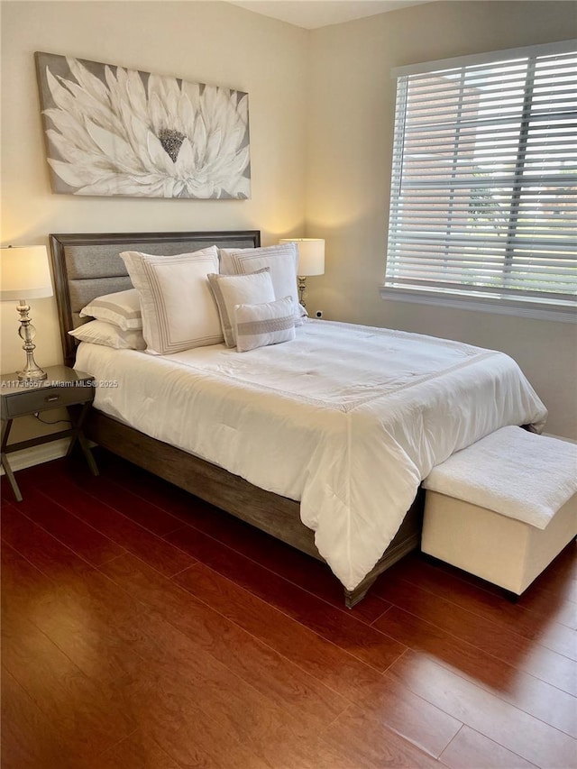 bedroom with dark hardwood / wood-style floors