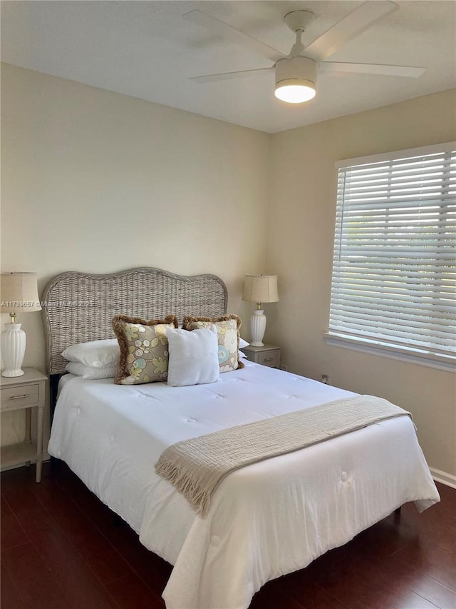 bedroom with dark hardwood / wood-style floors and ceiling fan